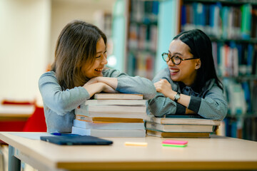 Positive student portrait at library with stacked books showing self directed learning motivation academic journey.