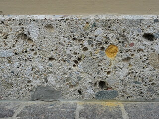 Historic base made of conglomerate with colorful pebbles. Close-up. Copyspace.
