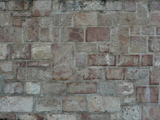 Irregular natural stone masonry with varying colors, textures and joints.