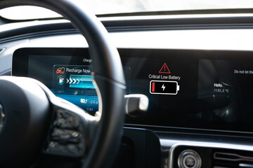 Electric vehicle range anxiety concept with low battery indicator on car dashboard