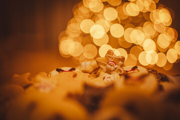 Christmas cookies close up. Christmas cookies on a glass tray. In background Christmas tree. Christmas lights.
