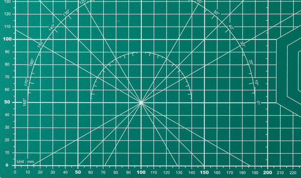Green cutting mat with grid and measurement markings for precision work
