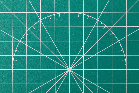 Green cutting mat with grid and protractor lines
