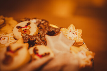 Christmas cookies close up. Christmas cookies on a glass tray. In background Christmas tree. Christmas lights.