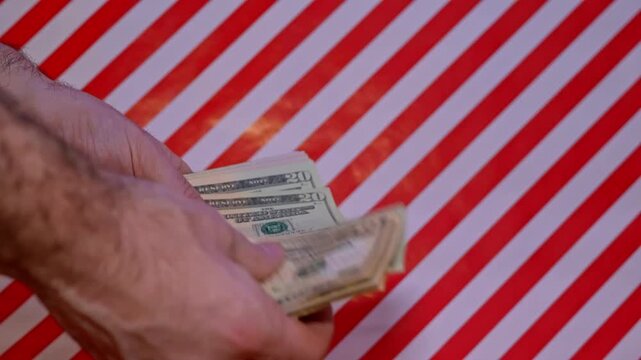Close Up Of Male Counting Money United States Dollars On Christmas Red And White Background