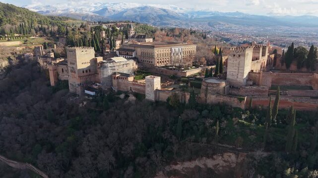 Famous Alhambra palace complex in Granada, Andalusia, with the Sierra Nevada mountains in the background