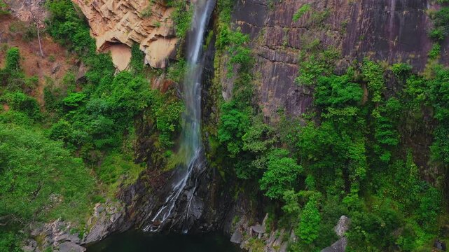 Dynamic drone tracking shot of the Cachoeira do Cato&aacute; (Cato&aacute; Waterfall), located in the remote Campo Alegre district of Paran&atilde;, Tocantins of the Serras Gerais region, Brazil
