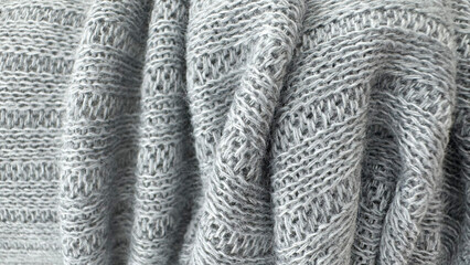 Soft gray knitted wool fabric texture background with detailed yarn pattern