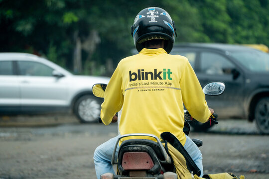 Delivery rider partner worker for 10 min hyper local quick commerce delivery app Blinkit from Eternal showing the rapid rise of these services across India