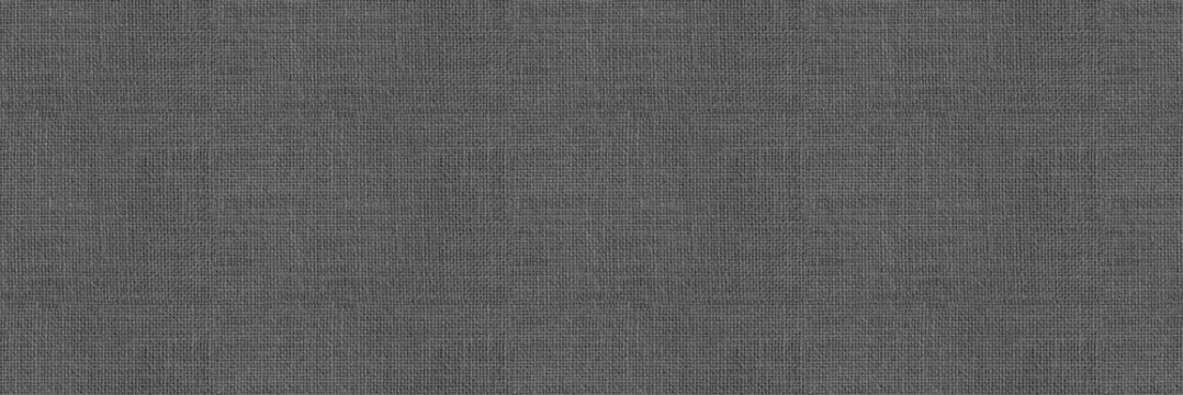 Shaded colourless upholstery background. Gray seamless fabric neutral background texture. Panoramic banner close-up of cloth material.