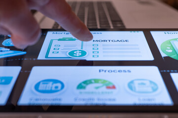 Finger interacting with a touch screen tablet displaying a mortgage application process, showing steps for loan approval, credit score evaluation, and financial assessment in real estate