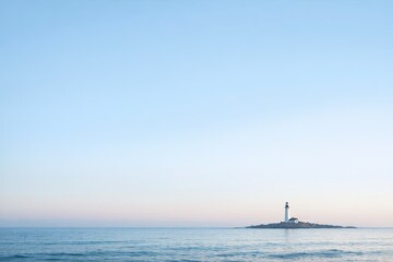 Fototapeta premium Lone Lighthouse on a Small Rocky Island in a Calm Blue Sea