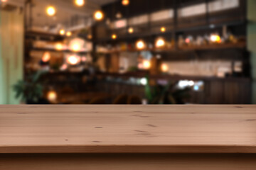 Empty wooden table and blurred bar interior. Space for design