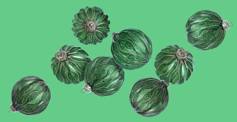 Christmas balls flying in air on green background