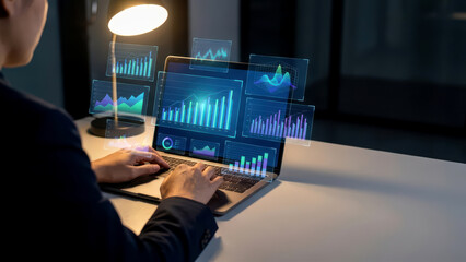 Businessman Analyzing Data and Financial Graphs on Laptop with Interactive Holographic Display