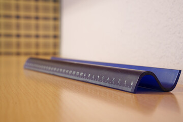 Wellarranged workspace highlighting triangular blue measuring device against patterned background