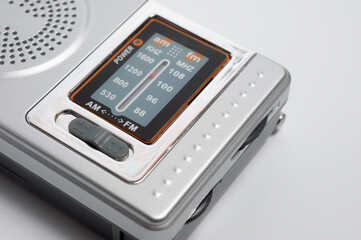 Fototapeta premium Portable battery-powered AM/FM radio photographed against a white background.
