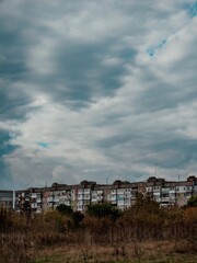 Obraz premium Typical eastern european architecture and autumn nature under heavy grey storm clouds 