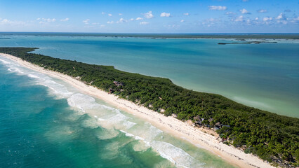 Sian Kaan Biosphere Mexico Beautiful beach with a green forest in the background. The ocean is calm and the sky is clear