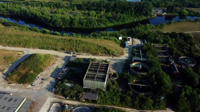Aerial drone flight over abandoned sewage works beside Aire and Calder Canal in Yorkshire