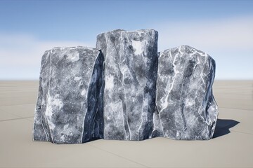 Three mottled, grey, textured rocks sit against a blurred background