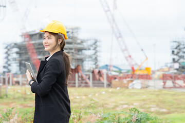 Female engineer managing industrial plant safety and machinery, working with her company to ensure business stability, operational control, and long term industry performance.
