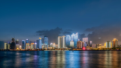 Fototapeta premium Illuminated City Skyline at Dusk by Water
