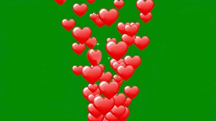 Multiple red hearts floating upwards on a green background in a visually appealing and celebratory manner perfect for valentine's day or romantic occasions and designs