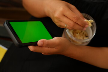 Smartphone with Green Screen and Banana Chip Snack