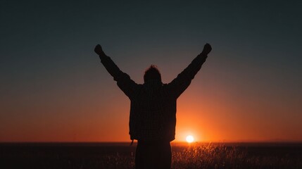 Silhouette of Freedom: A solitary figure, arms outstretched towards the radiant horizon, embodies the spirit of freedom and aspiration against the backdrop of a breathtaking sunset. 