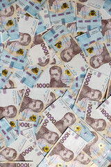 Obraz premium Background filled with Ukrainian national currency close-up. Thousand hryvnia bills demonstrate prosperity and prosperity. Representing monetary earnings from successful investments