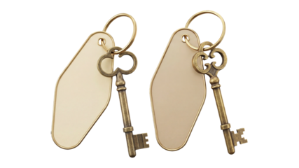 Two antique brass skeleton keys attached to blank hotel key fobs, vintage style ornate keys with cream colored plastic tags, retro motel or apartment security access concept