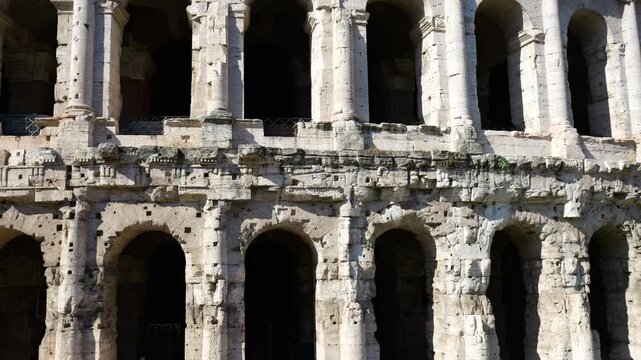 teatro di marcello&rsquo;s weathered limestone arches columns intricate eroded roman under bright sunlight rome up close empire marcello architecture close-up 