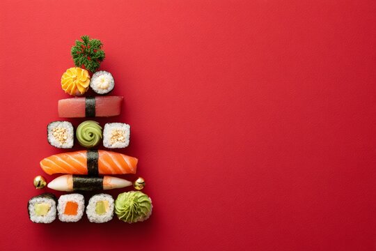 Sushi christmas tree creating holiday food art on red, copy space