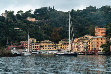Portofino, Italy. Colorful harbor waterfront with yachts and hillside village