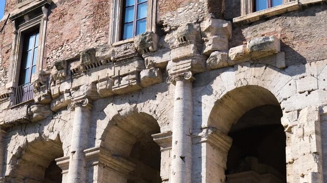weathered stone arches ionic columns characterize theatre marcellus fa&ccedil;ade topped by brick renaissance era structure tall windows patched masonry rome italy of 