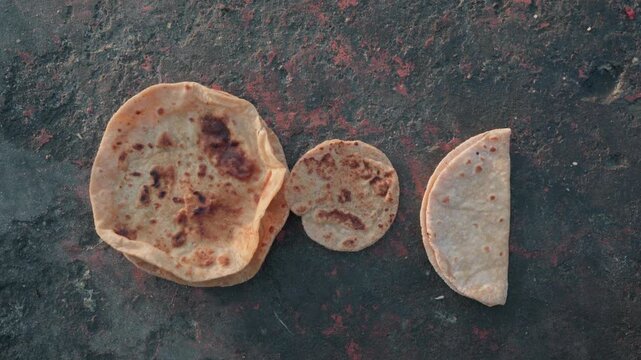 Chapatis kept on the road for a stray dogs, birds to feed on.