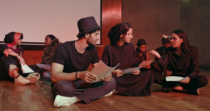 Indian young adult gen z male man female group hold script paper read new story line learn drama at studio teen girl boy team talk speak share new plan idea enjoy day spend break time hall stage place