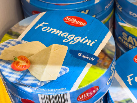 Bled, Slovenia - December 17, 2025: Milbona Formaggini cheese packaging displayed on shelf, featuring vibrant blue design and fresh tomato, ideal for culinary inspiration and food photography
