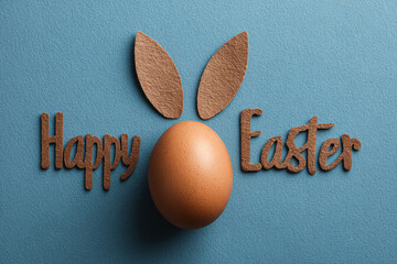 A simple and clean Easter greeting with a brown egg and bunny ears on a blue background