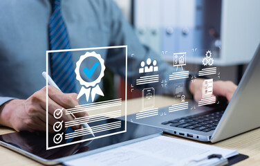 ISO certification and quality assurance concept with businessman using computer and tablet, symbolizing compliance, standards, and top-quality product management for modern businesses.