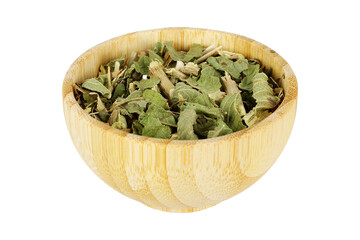 Lemon balm, Melissa officinalis, dried leaves in a wooden bowl isolated on a white background