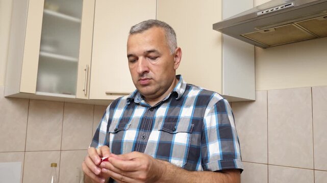 Man eating chocolate in the kitchen