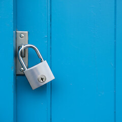 Open lock on blue door background. text security business web concept. Unlock padlock secure, protection, insurance and safety access.Business concept