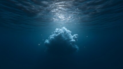 Obraz premium A surreal cloud formation floats in the deep blue ocean illuminated by ethereal sunbeams