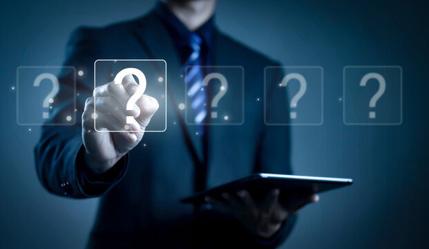 Businessman touching virtual question mark interface while using tablet, representing decision making, problem solving, customer support, FAQ, information technology, digital communication. - Powered by Adobe