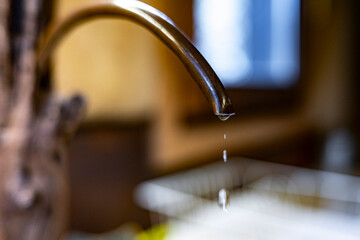 Dripping Water Tap Indoors, Close-Up of Faucet Leak and Water Waste