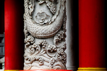 Stone Dragon Relief Carved on Temple Pillar, Traditional Asian Architecture Detail Symbolizing Power, Protection, Prosperity and Cultural Heritage