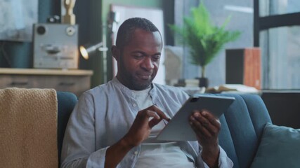 Person enjoys digital entertainment calmly, Individual sitting peacefully engaging with devices and art