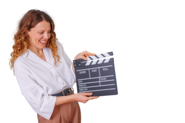 Woman holding movie clapperboard, smiling and acting as director or film producer, isolated on transparent background